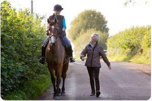 Rosie withey with a riding client teaching reflective riding in somerset uk