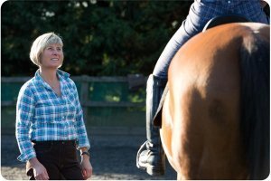 Rosie Withey from horses as teachers coaching a riding client during a workshop near Bristol UK