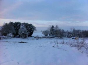 A view of brickyard farm in the snow, where horses and humans work together inspired by eponaquest in the uk