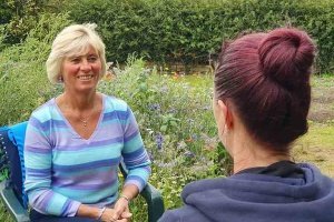 an emotional wellbeing coaching session taking place in natural surroundings