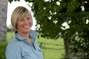 Portrait of Rosie Withey smiling. Rosie is an emotional wellbeing coach and equine facilitated learning instructor working in Somerset uk