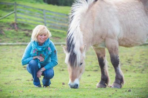 efl workshop leader with grazing horse in somerset uk