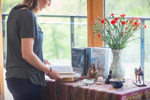 woman standing at altar reading a book